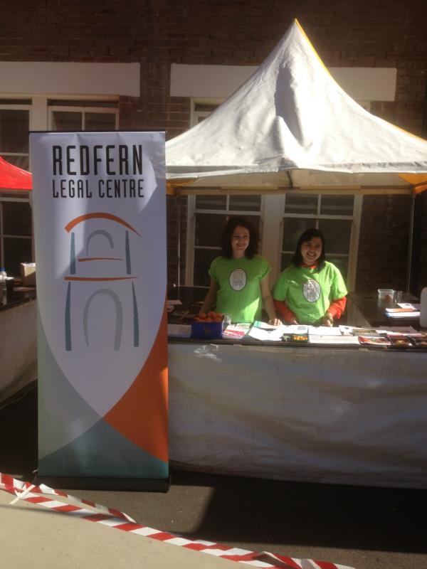 Two workers in green shirts at an RLC stall