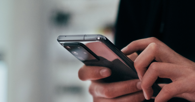 Close up of a person's hands holding a mobile phone