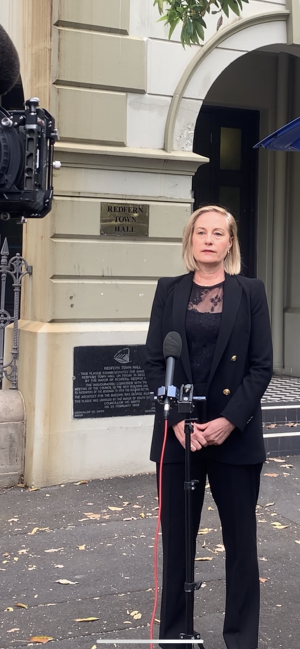 Sam Lee stands in front of RLC being interviewed by Sunrise