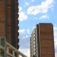 Two apartment blocks against blue sky