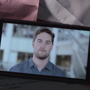 Still video image of a man on a mobile phone screen