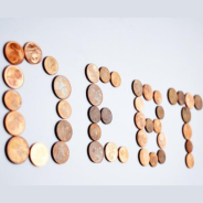 Coins spelling the word debt