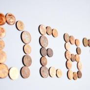 Coins spelling the word debt