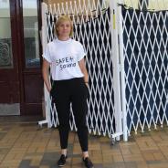 A woman with blonde hair in a teeshirt that reads Safe and Sound