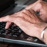 hands typing on a laptop keyboard