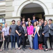 Large group of people standing and smiling outside Redfern Legal Centre's front steps