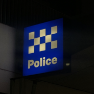Image of light up police sign at night