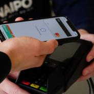 A person paying for credit purchase using a mobile phone