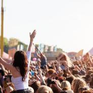 Girl crowd surfing at music festival